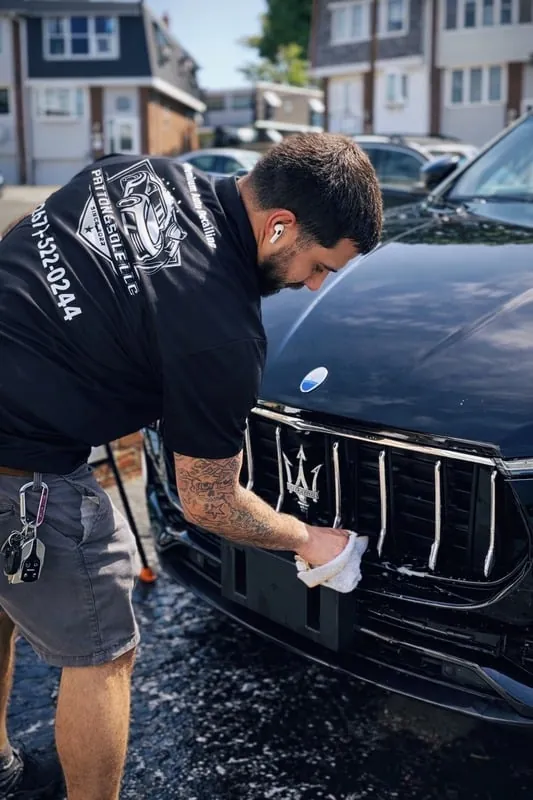 Wiping the front grille of a black SUV
